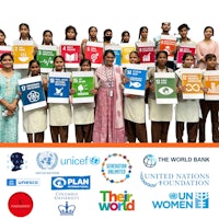 a group of women holding signs for the world bank